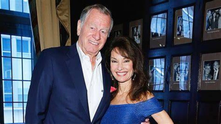 Helmut Huber in a blue coat and grey pants with his wife Susan Lucci in a white formal attire.
